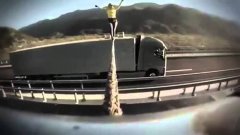Tightrope walking between two moving Volvo trucks stunt