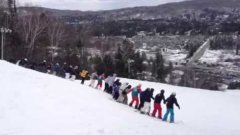 30 skiers back flip together