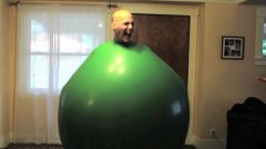 Guy Climbs Inside A Giant Green Balloon