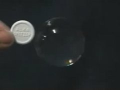 Alka-Seltzer tablet added to a water drop in zero gravity
