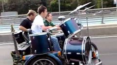 Russian Band Playing On Motorcycle Driving Down Highway