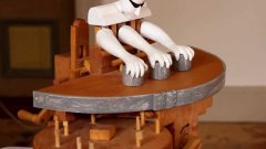 Three armed wooden robot shell game