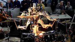 4 armed mohawked robot playing the drums
