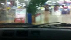 Giggling teens drive car through polish mall