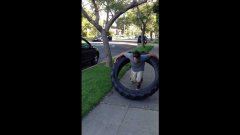 Man hula-hoops with 100 pound monster truck tire