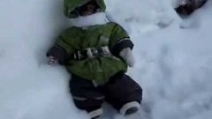 Monkey wearing tiny coat plays in snow