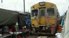 Train drives through Bangkok market