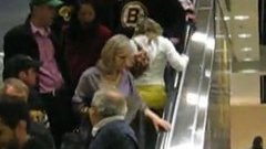 Blonde climbing an escalator