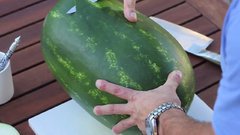Man carves watermelon into something beautiful.