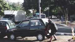 Strong Cyclist Lifts a Tiny Car Out of the Bike Lane