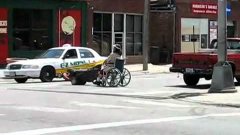 Woman On Wheel Chair Uses Lawn Mower To Move